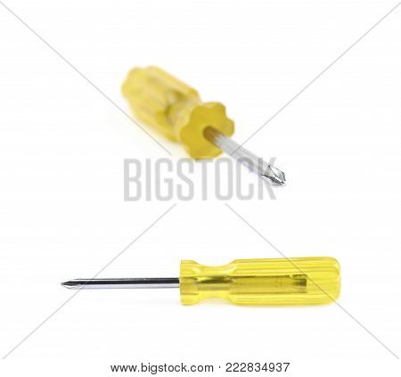 Tiny crosshead screwdriver with a plastic yellow handle, isolated over the white background, set of two different foreshortenings