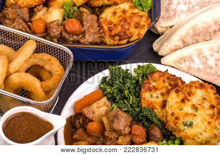 Beef in Irish Stout Stew with Dumplings
A dish of Beef in Irish stout with a topping of cheese and spring onion Dumplings, served with a selection of vegetables and Sourdough bread, with stout battered onion rings and a jug of onion gravy.