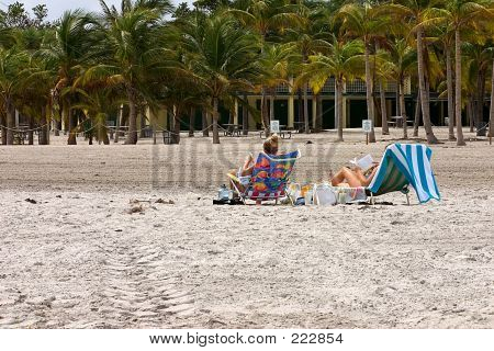 Women Reading On Beach