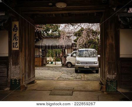 Nara, Japan - Apr 4, 2014. Ancient wooden house at cherry blossom in Nara, Japan. Nara is Japan first permanent capital, was established in the year 710 at Heijo.