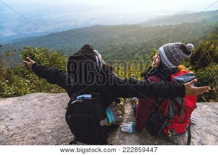 Lover women and men asians travel relax in the holiday. Admire the atmosphere landscape on the Moutain. Mountain Park happily. In Thailand