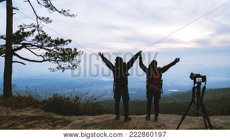 Photographer lover women and men asians travel relax in the holiday. Photograph mountain landscapes atmosphere in the morning. In the winter. In Thailand