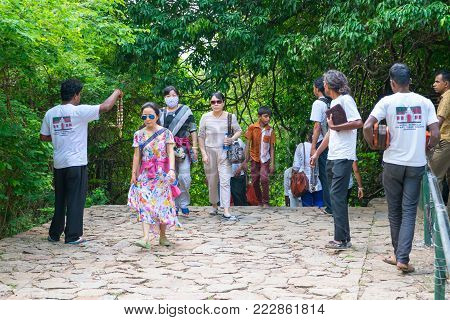DAMBULLA, SRI LANKA - NOV 2016: Obtrusive souvenir dealers propose their goods to tourists on a way to Golden cave temple.