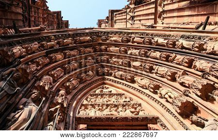 trave to France - west outdoor portal of Strasbourg Cathedral on square Place du Chateau in summer evening