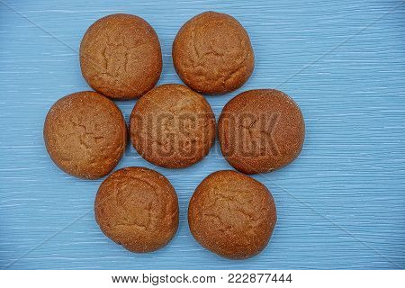 a pattern of round bread rolls on a table