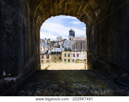 SEDAN, FRANCE - JUNE 30, 2010: view of town through embrasure of castle Chateau de Sedan in summer day. Sedan is a commune in Ardennes department, the castle began to be built in 1424