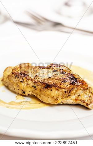 Grelled pork chop steak on white dish on white background