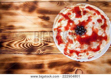 Slapjacks with berries and jam on burnt boards