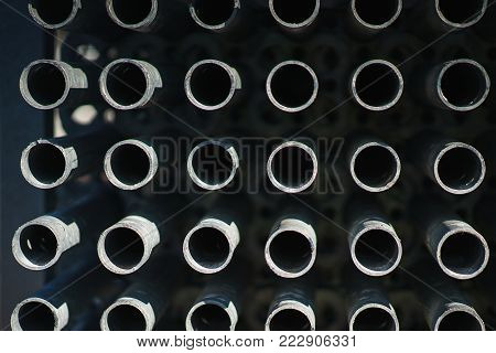 metal structures in a warehouse in stacks. metal supports for scaffolding and formwork. soft focus and bokeh.Outdoors storage of building materials and metal structures.