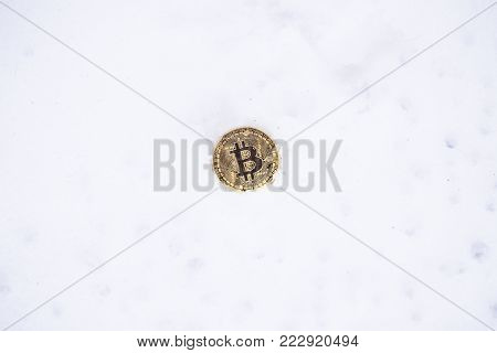 Bitcoin on the snow. Isolated on white background.