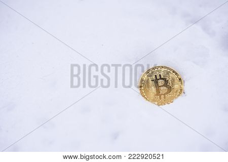 Bitcoin on the snow. Isolated on white background.