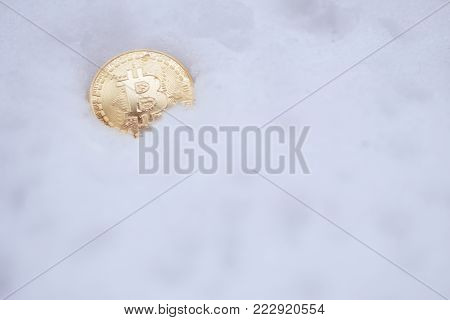 Bitcoin on the snow. Isolated on white background.