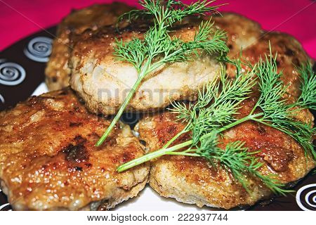 Homemade chicken cutlets and fresh greens. Plate full of delicious chicken cutlets prepared for eat. Fried chicken cutlets fresh greens on the plate