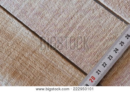 Measuring tape of roulette on wooden boards close-up