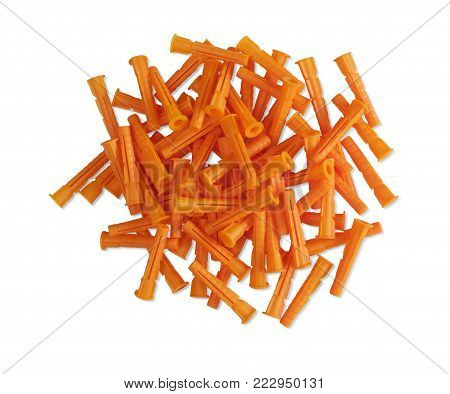 a pile of orange plastic dowels on isolated white background