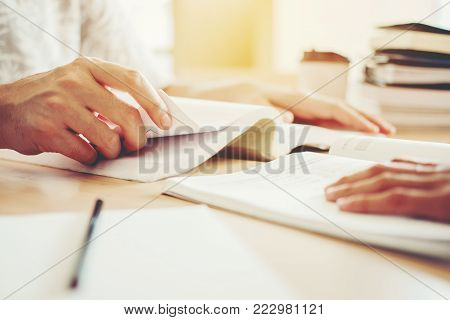 High School Or College Students Studying And Reading Together In Library
