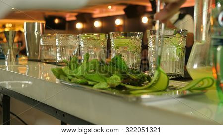 The Process Of Cooking Five Cocktails From Cucumber, Mint, Lime Juice, Ice And Mineral Water, The Ba