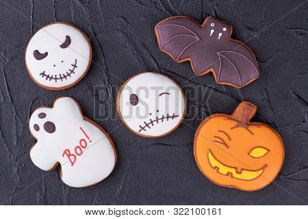Colorful Halloween Cookies On Black Slate. Homemade Gingerbread Biscuits In A Shape Of Bat, Ghost, P