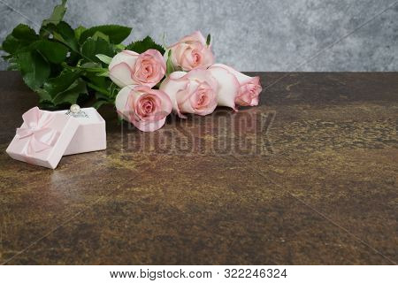 Roses On Rusty Table With Gray Background