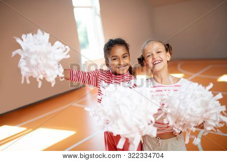 Best Friends Smiling While Practicing Cheerleading Together