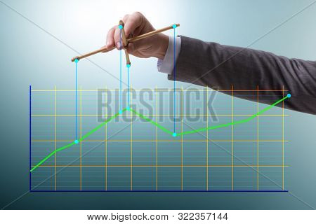 Businessman controlling the market with strings