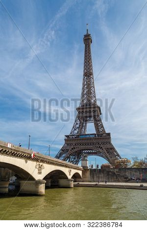 Paris, France, March 30, 2017: Tour Eiffel (Eiffel Tower), river Seine at sunset. Eiffel Tower, named after engineer Gustave Eiffel, is tallest structure in Paris and most visited monument in world