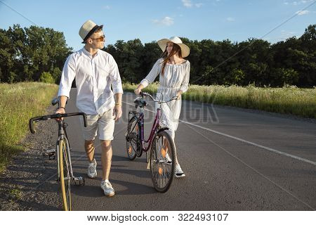 Couple Of Bicycle Fellow Travelers Chatting On A Sunny Countryside Road