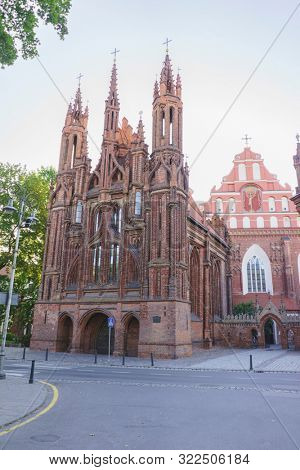 VILNIUS, LITHUANIA - JULY 30, 2019:  Facade of Roman Catholic Church of St. Anna in Vilnius (lit. Church of the Holy Onos) and  Church Of St. Francis And St. Bernard, UNESCO World Heritage