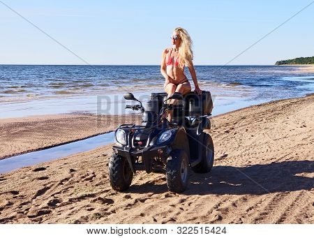 Attractive Woman In Bikini And Sunglasses With Long Blonde Hair Is Sitting On The Quad Bike, Sunny D
