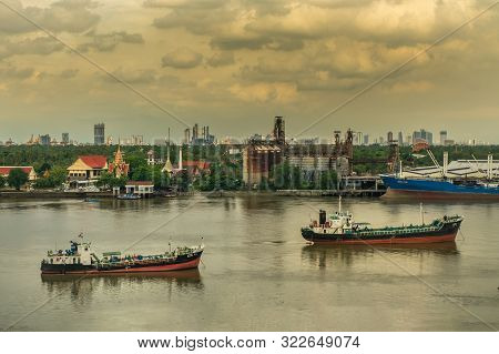 Bangkok, Thailand - 05 Aug 2019 :  Cargo Ships In The Middle Chao Phraya River And The Back Is Green