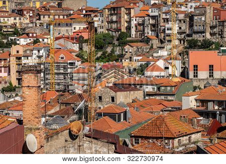 Porto, Portugal - 12 August 2019: Mulitple Cranes Showing New Construction Work Near The Cathedral I