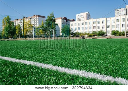 Kyiv, Ukraine - September 02, 2019. Mishugi St. School stadium. Artificial grass, white lines, soccer goal on sunny day
