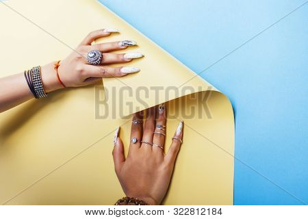 Woman Hands Holding Colorful Paper Copyspace Wearing A Lot Of Jewelry And Long Nails Closeup