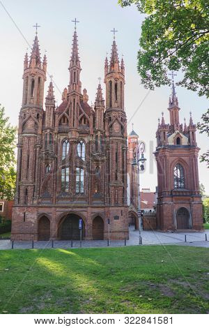 VILNIUS, LITHUANIA - JULY 30, 2019:  Facade of Roman Catholic Church of St. Anna in Vilnius (lit. Church of the Holy Onos) and  Church Of St. Francis And St. Bernard, UNESCO World Heritage