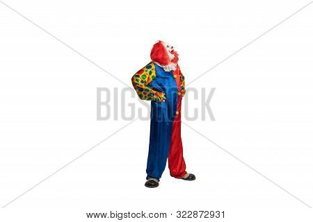Funny Clown With Costume And Makeup Looks To The Side