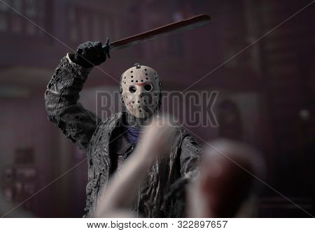 SEPT 17 2019: Horror movie slasher Jason Voorhees hacking a victim at Camp Crystal Lake - Neca Jason action figure