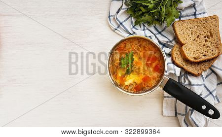 Traditional Russian Vegetable Soup Shchi In A Ladle And Bread On A White Background. Top View