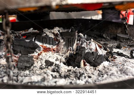 A Large Round Grill On The Coals In Which Grilled Color Vegetables And Fresh Meat Sousages Are Cooke