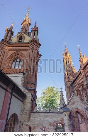 VILNIUS, LITHUANIA - JULY 30, 2019:  Facade of Roman Catholic Church of St. Anna in Vilnius (lit. Church of the Holy Onos) and  Church Of St. Francis And St. Bernard, Details, UNESCO World Heritage