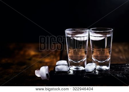 Cold Cocktail With Tonic, Vodka And Ice On The Wooden Background. World Vodka Or Brandy Day