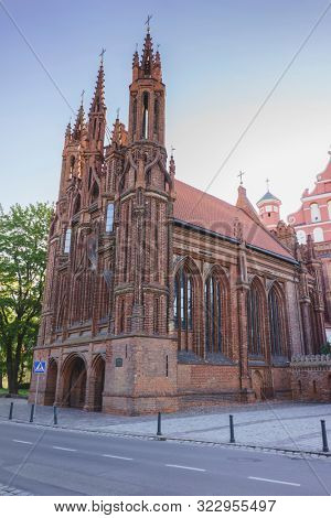VILNIUS, LITHUANIA - JULY 30, 2019:  Facade of Roman Catholic Church of St. Anna in Vilnius (lit. Church of the Holy Onos) and  Church Of St. Francis And St. Bernard, UNESCO World Heritage