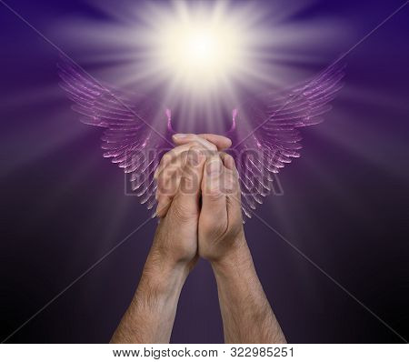 Praying For Help From The Angelic Realms - Male Hands In Praying Position With A Bright White Light 