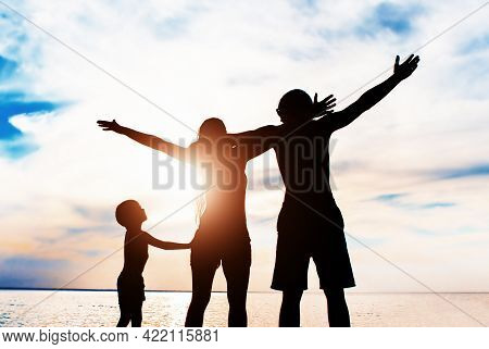 Happy Family Silhouette With Hands Up On The Nature Background