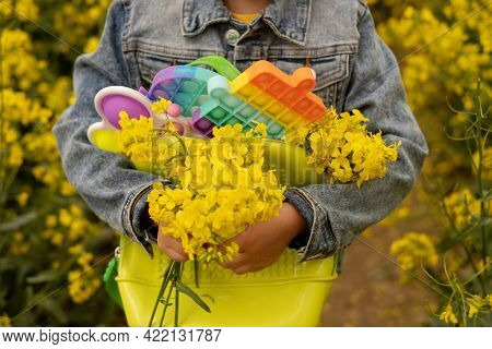 A Girl In A Rapeseed Field With A Backpack Filled With Modern Educational Popit And Simple Dimple To