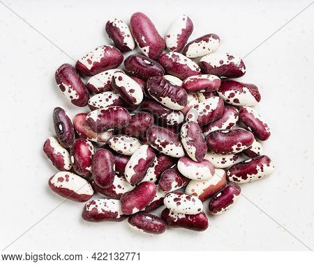 Pile Of Red Speckled Kidney Beans Close Up On Gray Ceramic Plate