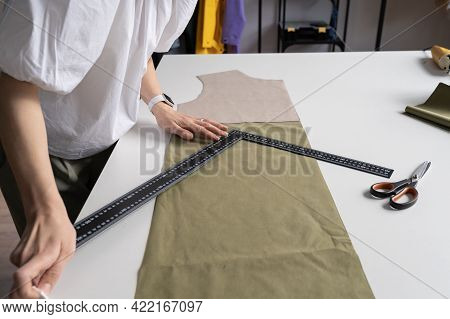 Tailor Couturier Measuring Fabric. Closeup Of Professional Sewer Female Use Triangle Ruler To Cut Ma