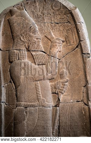 Berlin, Germany - 18 September 2019: Babylonian bas relief in Berlin Pergamon museum in Germany. Historical ancient art of east religion and civilization made on stone wall.