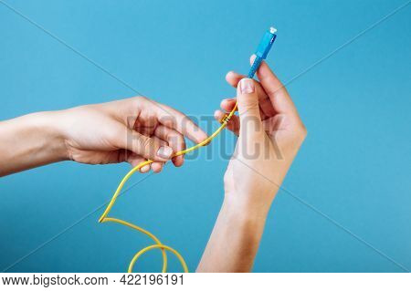 Womans Hands Hold Sc And Fc Connector Fiber Optic Patch Cord Single Mode On Blue Background