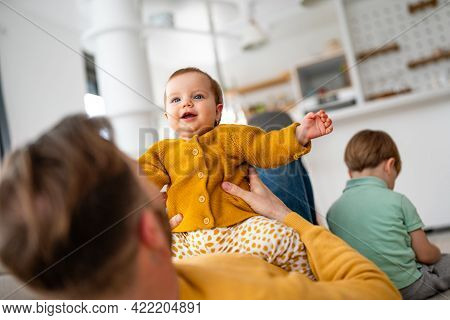 Unhappy Little Boy Feeling Jealous While Perent Spending Time With His Baby Sister At Home