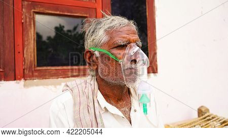20 May 2021- Reengus, Sikar, India. A Elder Person Infected With Covid 19 Disease. Patient Inhaling 